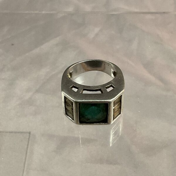 Close-up of a silver gents ring with a vibrant aqua stone.