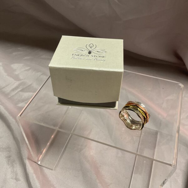 Sterling silver spinner ring with brass and copper bands, size V.