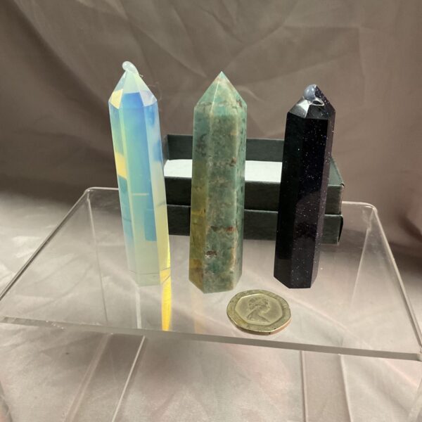 Iridescent crystal point on display, beautiful healing crystal.