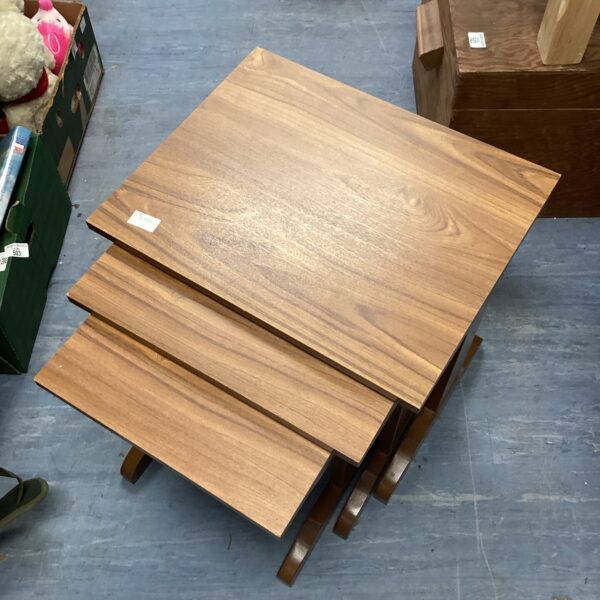 Vintage wooden nest of tables in graduated sizes.