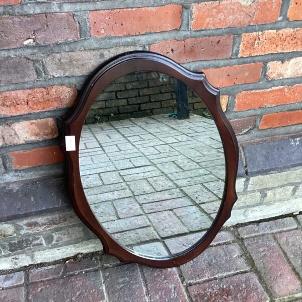 Antique mahogany framed oval mirror for vintage home decor.