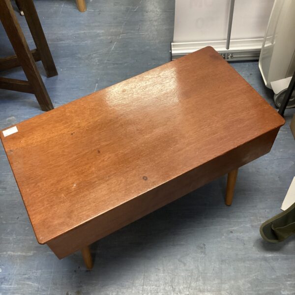 Vintage wooden sewing box with tapered legs.