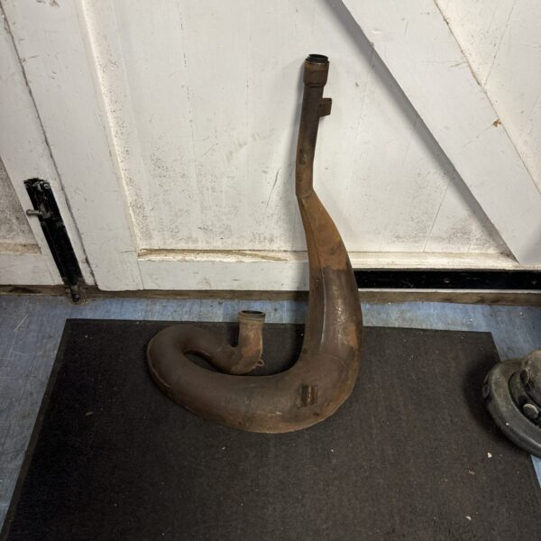 Vintage exhaust pipe, possibly for a Honda C250R motorcycle.