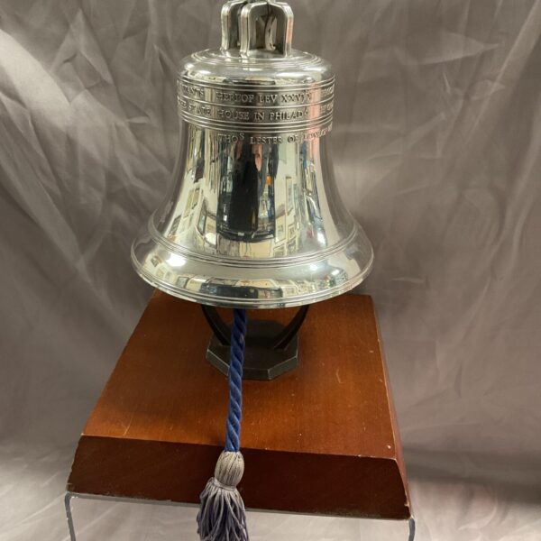 Detailed silver plate Liberty Bell replica with tassel.