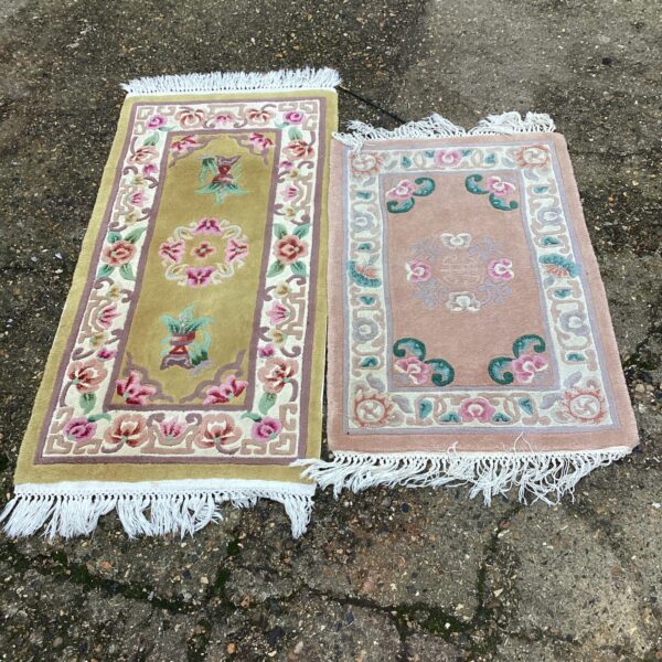 Vintage rug pair with floral and geometric designs.