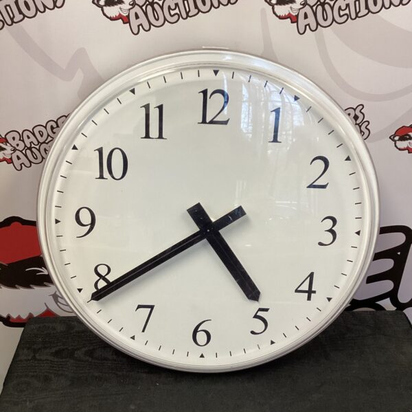 Large vintage wall clock with bold black hands.