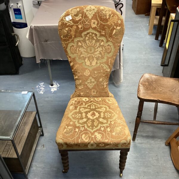 Antique balloon back chair with floral upholstery, vintage furniture.