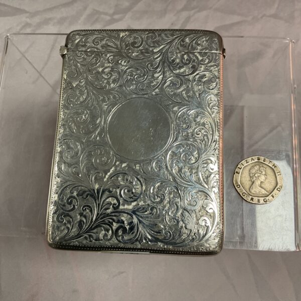 Intricate silver card case, Chester 1900 hallmark, antique collectible.