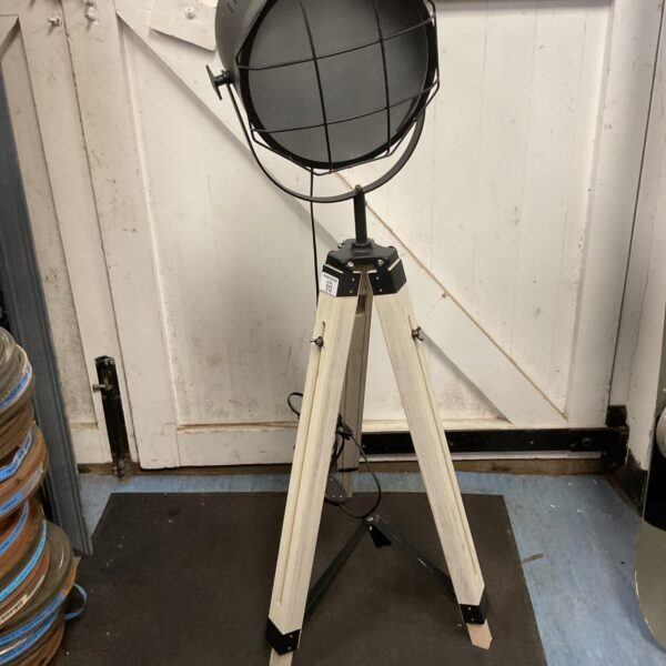 Vintage film set light on wooden tripod.