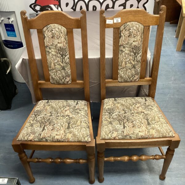Vintage oak dining chairs with tapestry seats, a charming pair.