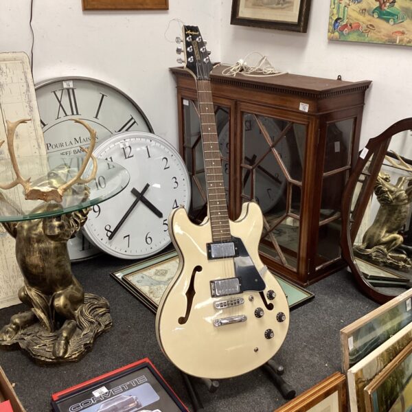 Vintage Aria Pro II guitar in a shop setting.