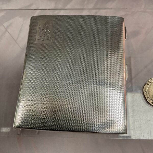 Vintage sterling silver cigarette case with ribbed texture.