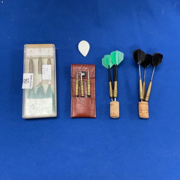 Vintage Unicorn darts set in worn case, collectible dart game.
