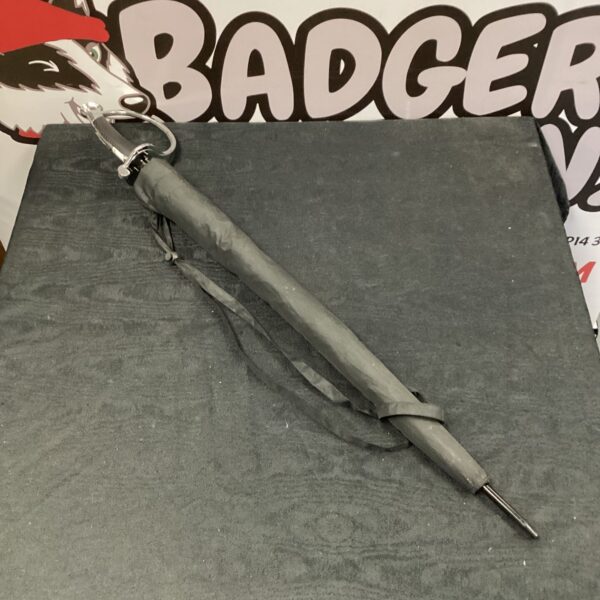 Close-up of the sword-handled umbrella, showing the detailed grip.