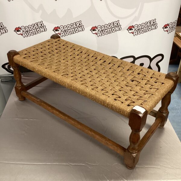 Vintage woven footstool with rustic farmhouse style.