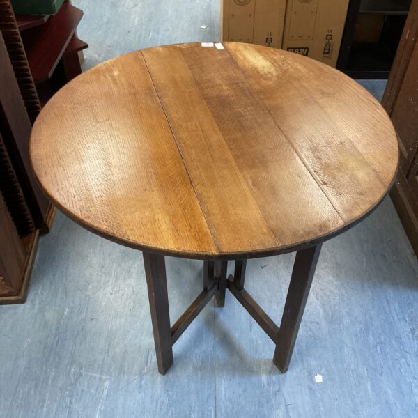 Antique mahogany gate leg table with round top.