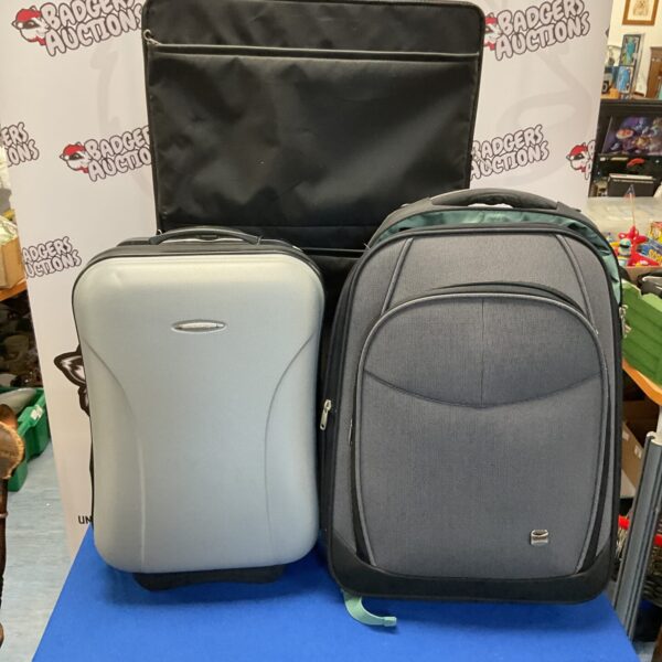 Dark-coloured luggage set with rolling wheels for travel.