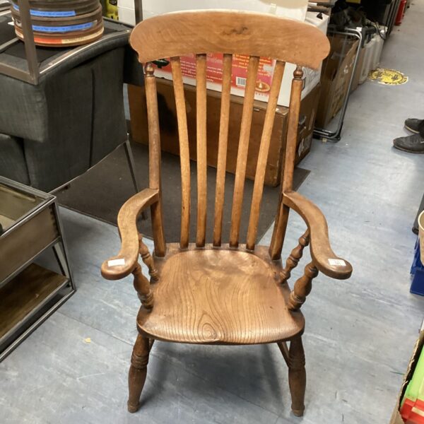 Front view of a Victorian oak armchair needing restoration.