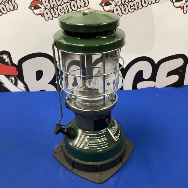 Vintage Coleman oil lamp with green enamel finish.