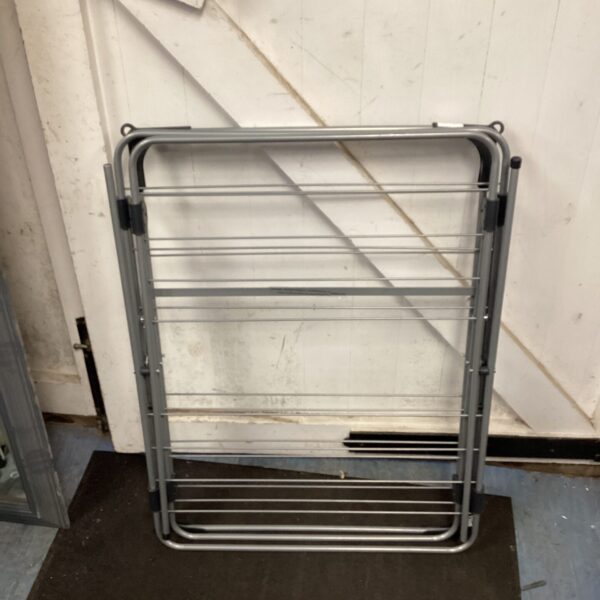 Silver metal folding clothes airer for indoor laundry.