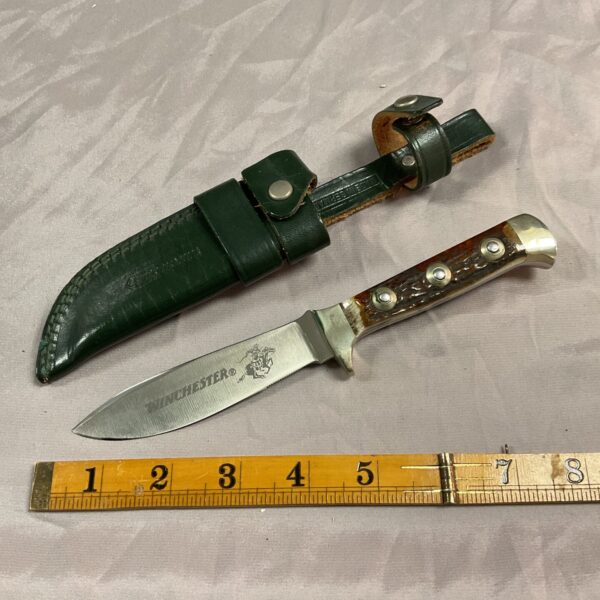Vintage Winchester knife with horn handle and leather sheath.