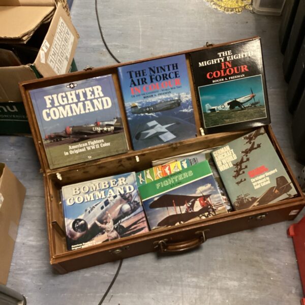 Vintage leather case holding WWII military aviation books.