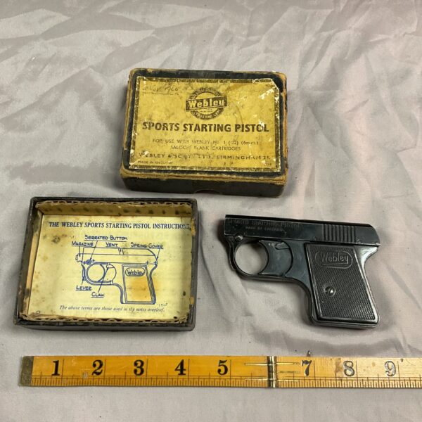 Vintage Webley starting pistol displayed in its original box.