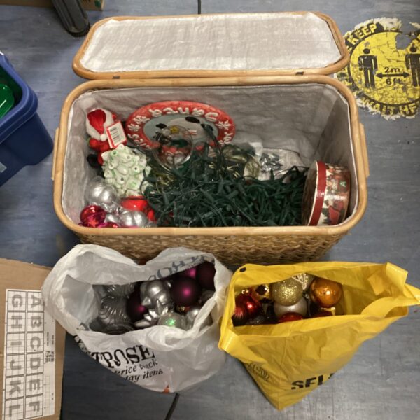 Christmas decorations bundle with baubles and lights inside a basket.