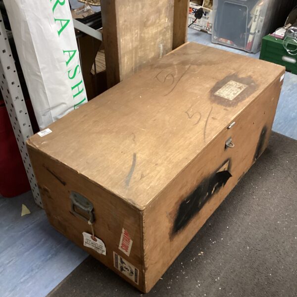 Front view of a large vintage wooden trunk.