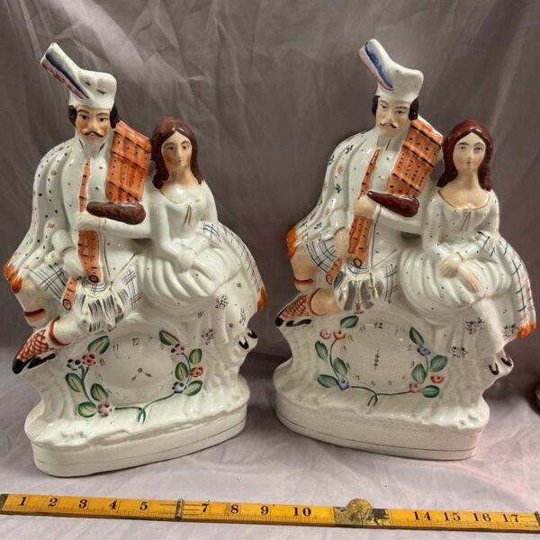 Antique Staffordshire Highland couple flatback figurines in vibrant colours.