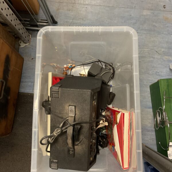 Black bass amplifier within a house clearance lot.