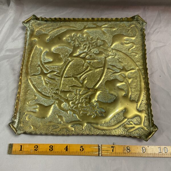Antique brass tray with detailed embossed floral and avian design.