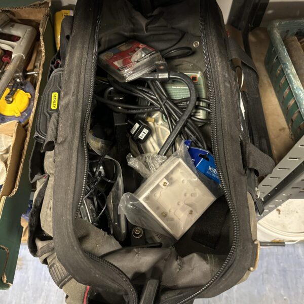 Used Stanley Fatmax tool bag filled with hardware and tools.