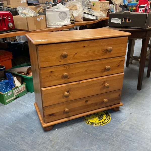 Vintage pine chest of drawers with four drawers for bedroom storage.