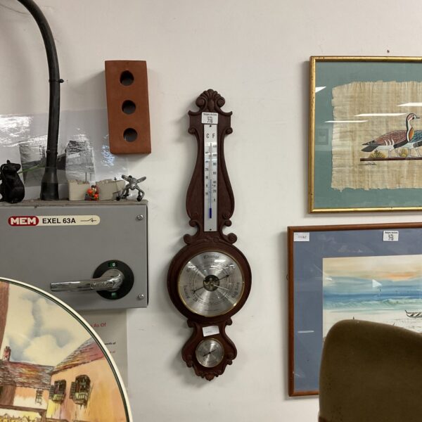Vintage Weathermaster barometer on a wall, classic weather instrument.