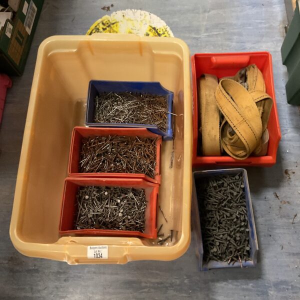 Close-up of mixed nails in a plastic tub.