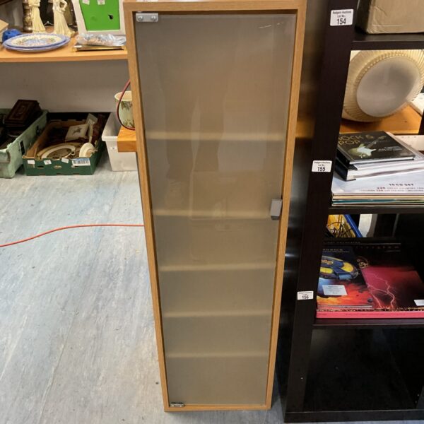 Tall narrow CD rack for media storage.
