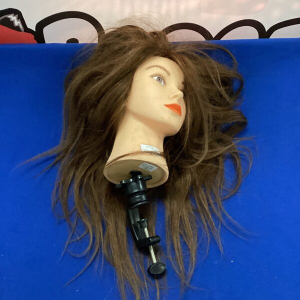 Brown-haired hairdressing mannequin head with clamp base.