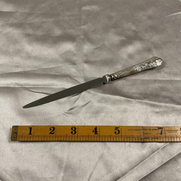 Antique sterling silver paper knife with floral handle.