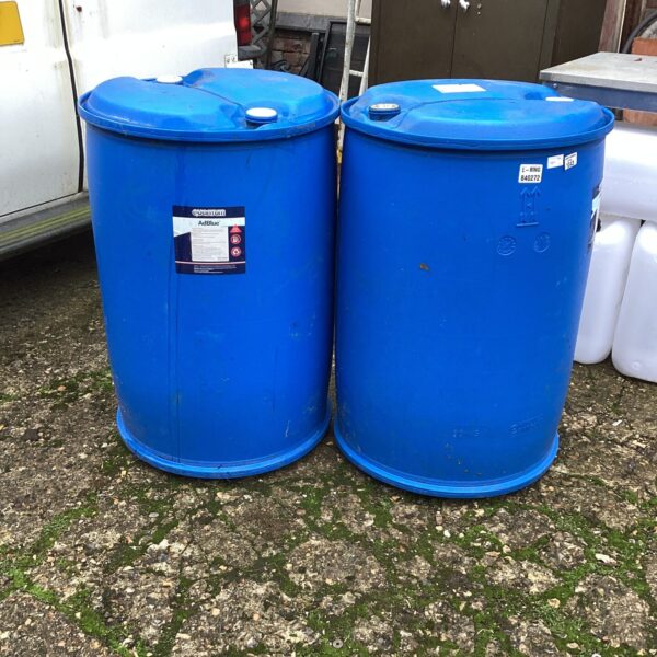 Pair of used plastic drums for storage and industrial use.