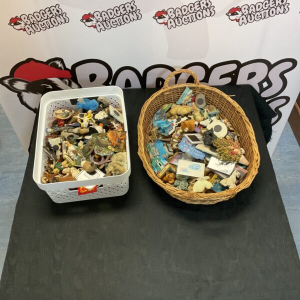 Mixed magnet collection in a wicker basket, colourful fridge decorations.