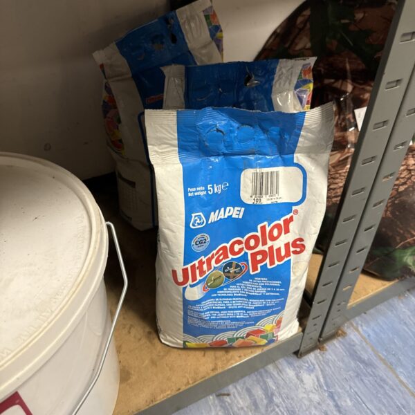Three bags of Mapei Ultra Colour Plus jointing compound for construction.