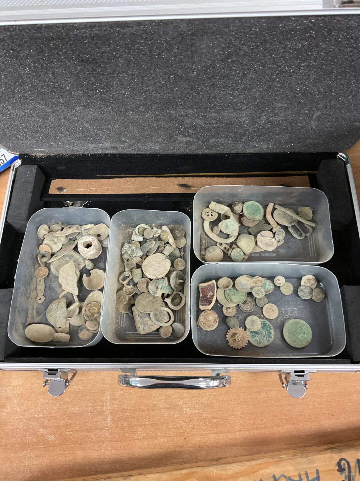654 aluminium case with trays of metal detector finds including coins