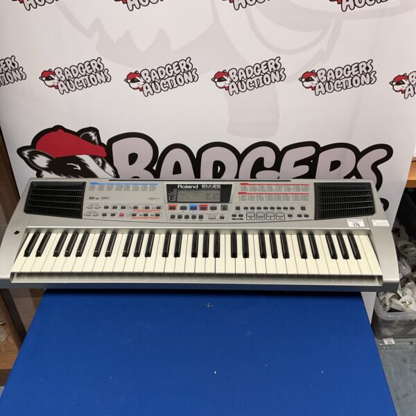 Vintage Roland EM-25 keyboard, 1980s synth instrument.