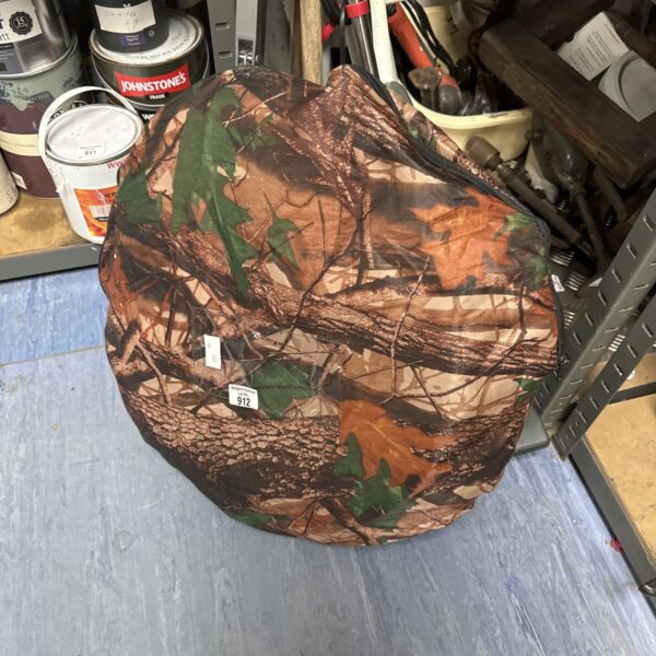 Camouflaged pop up shooters hide for outdoor hunting or shooting.