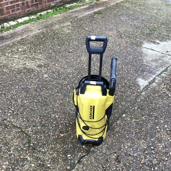 Front view of a used Karcher power washer for garden cleaning.