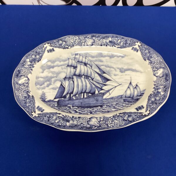 Antique blue and white transferware meat plate with sailing ship scene.