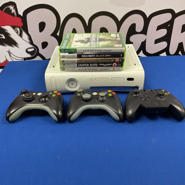 Xbox 360 console bundle with controllers and games displayed.