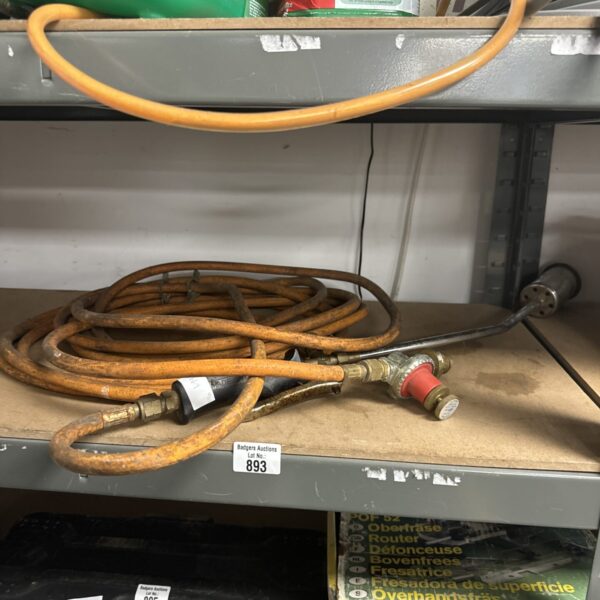 Vintage propane burner lance with regulator for heating applications.