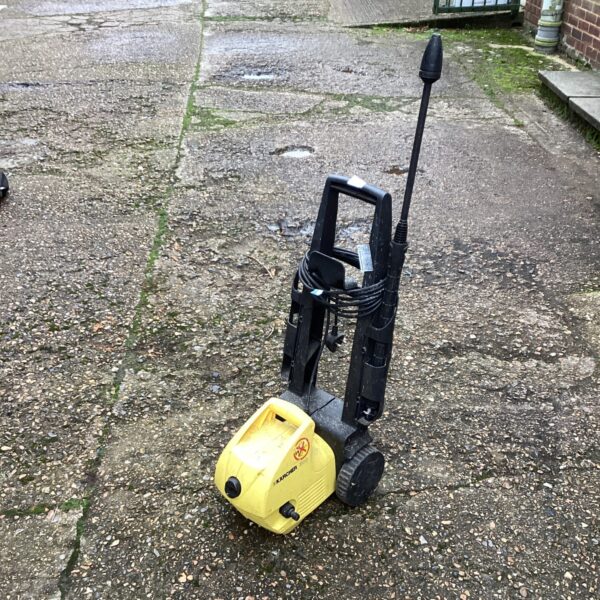 Yellow Karcher power washer for garden and patio cleaning.